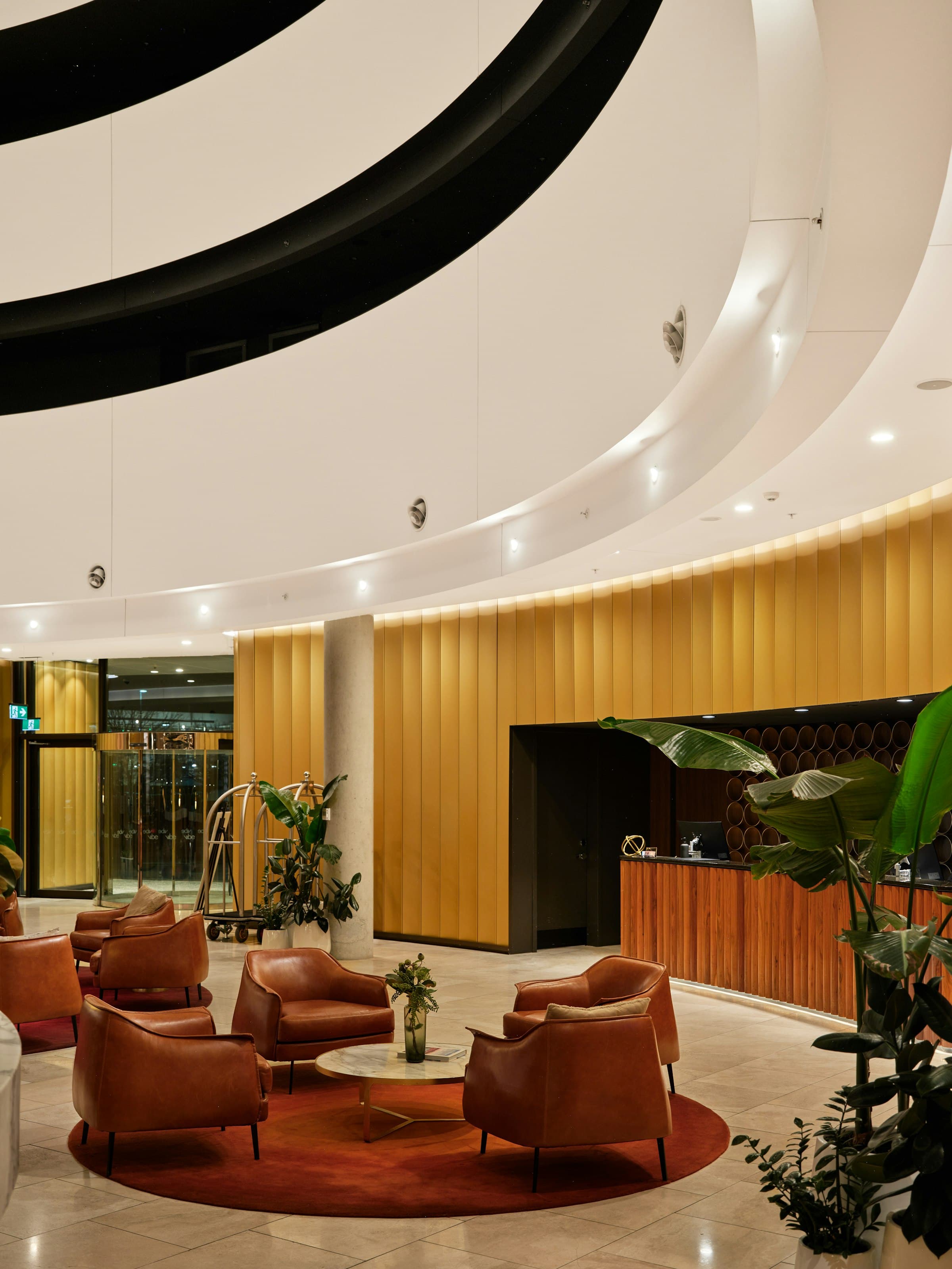 Hotel lobby desk with a computer and luggage trolley